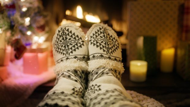 first-person-closeup-view-4k-footage-of-person-feet-wearing-warm-wool-socks-with-tradi-SBI-350991301